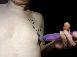 syringe suction of her nipple and piercing 
